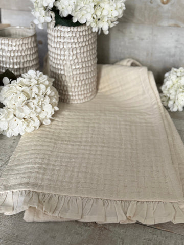 The cream stitched table runner
